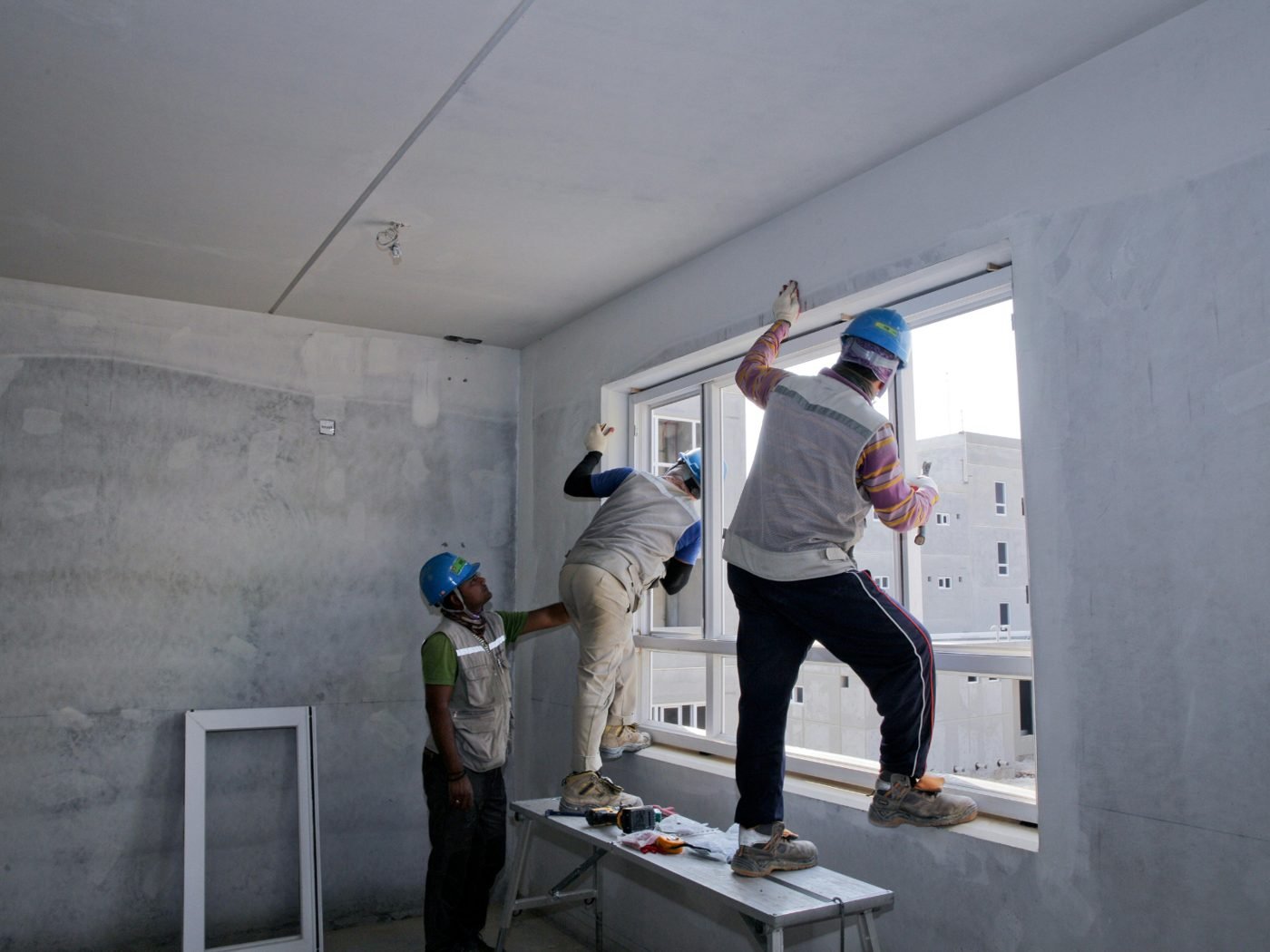 Team fitting a window opening